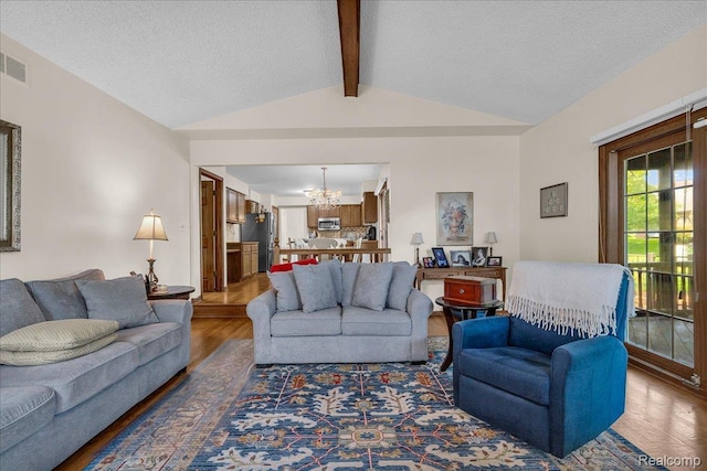 24842 White Plains Dr, Novi, MI 48374 - living room with a chandelier, wood finished floors, and a textured ceiling