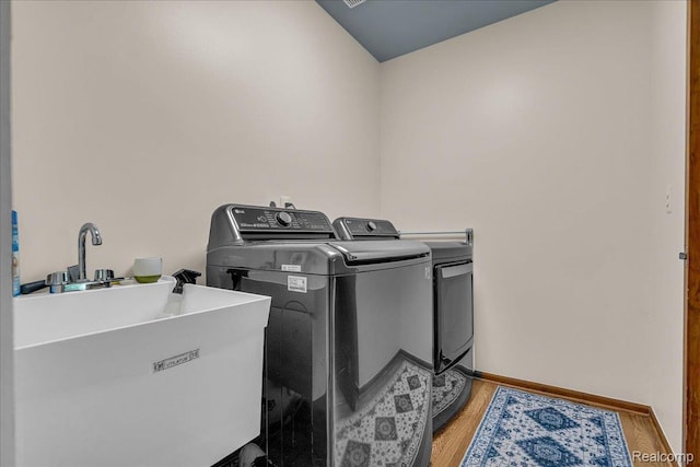 24842 White Plains Dr, Novi, MI 48374 - laundry area with washer and clothes dryer and light wood-style floors