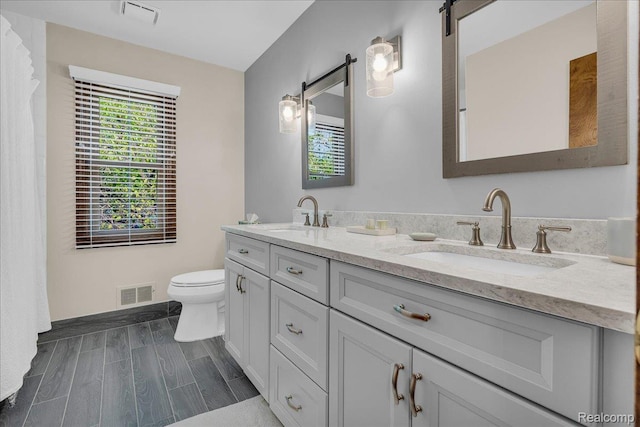 24842 White Plains Dr, Novi, MI 48374 - bathroom with double vanity and toilet