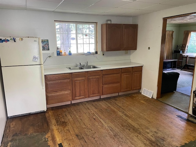 4120 S Washington Rd, Saginaw, MI 48601 - kitchen with freestanding refrigerator, a paneled ceiling, dark wood-style floors, and light countertops