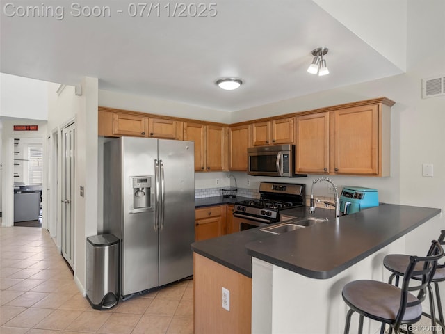 35033 Windsor Dr, New Baltimore, MI 48047 - kitchen featuring stainless steel appliances, a peninsula, dark countertops, and light tile patterned flooring