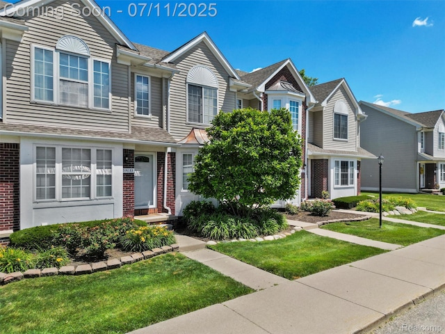 35033 Windsor Dr, New Baltimore, MI 48047 - townhome / multi-family property with brick siding and a front lawn