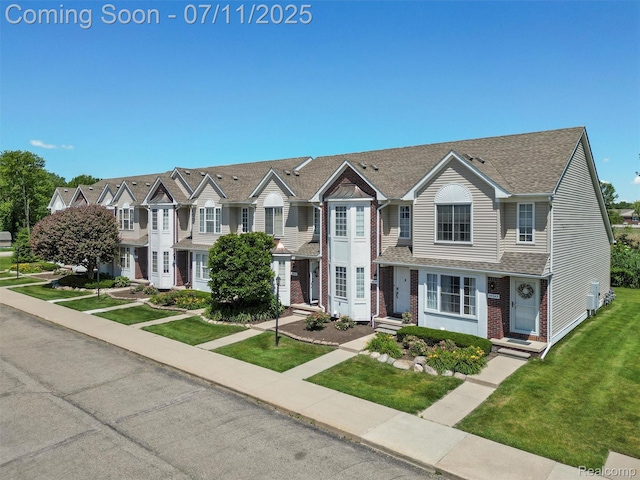 35033 Windsor Dr, New Baltimore, MI 48047 - view of property featuring brick siding, a front lawn, and roof with shingles