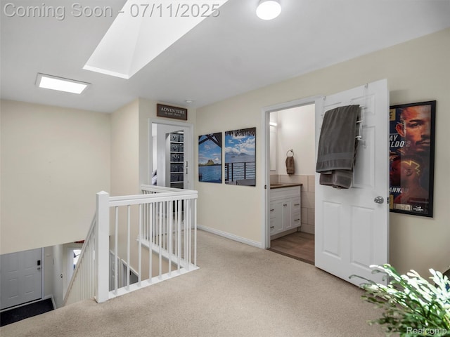 35033 Windsor Dr, New Baltimore, MI 48047 - hallway with carpet, an upstairs landing, and a skylight