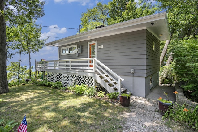 6881 Helena St, West Olive, MI 49460 - view of front of home with a deck and a front lawn