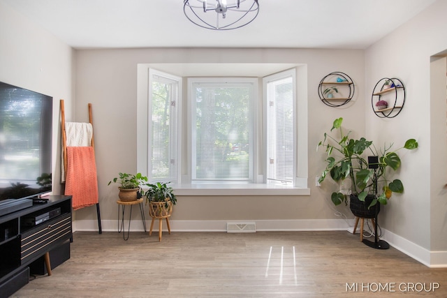 3255 Prairie St SW, Grandville, MI 49418 - entryway featuring light wood finished floors and a chandelier