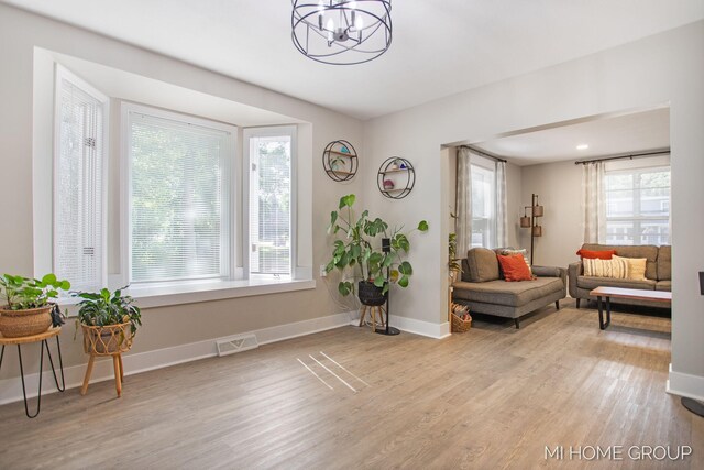 3255 Prairie St SW, Grandville, MI 49418 - sitting room with wood finished floors and a chandelier