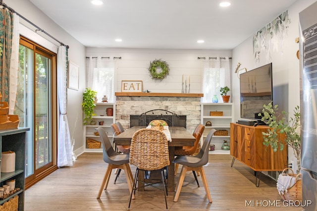 3255 Prairie St SW, Grandville, MI 49418 - dining area featuring wood finished floors, a fireplace, and recessed lighting