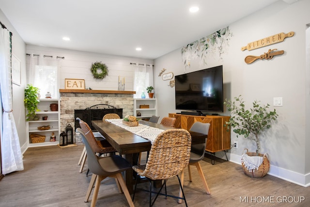 3255 Prairie St SW, Grandville, MI 49418 - dining room with wood finished floors, healthy amount of natural light, a fireplace with raised hearth, and recessed lighting