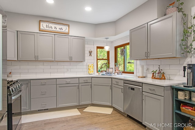 3255 Prairie St SW, Grandville, MI 49418 - kitchen with appliances with stainless steel finishes, gray cabinets, decorative backsplash, and recessed lighting
