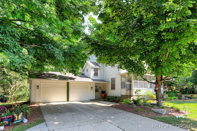 3255 Prairie St SW, Grandville, MI 49418 - obstructed view of property featuring a garage, driveway, and roof with shingles