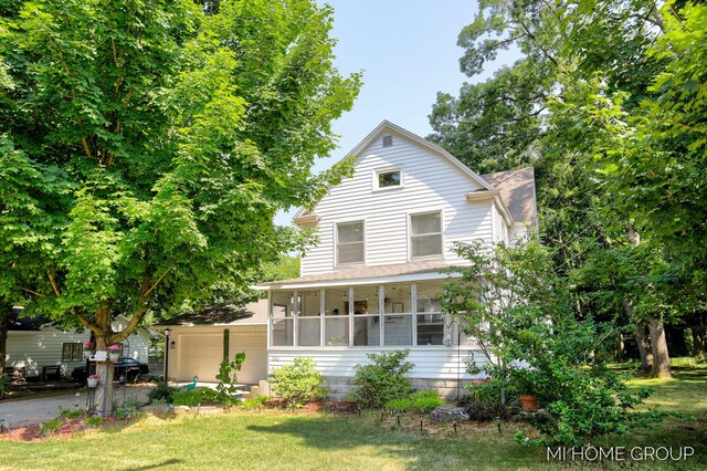 3255 Prairie St SW, Grandville, MI 49418 - view of front of house with roof with shingles, a sunroom, and a front lawn