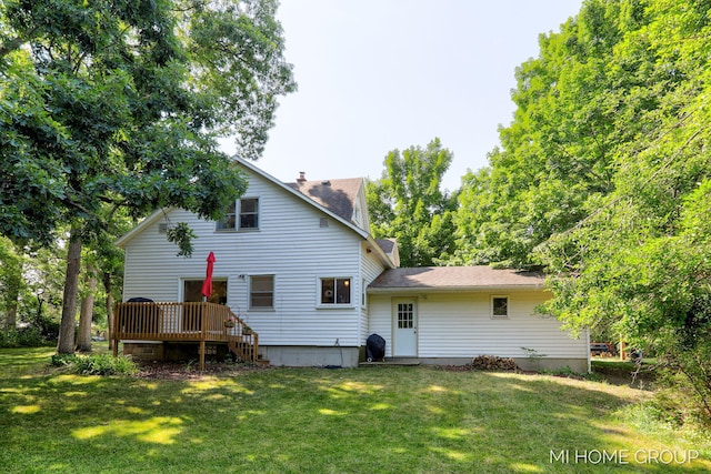 3255 Prairie St SW, Grandville, MI 49418 - rear view of property featuring a wooden deck, a chimney, a lawn, and roof with shingles