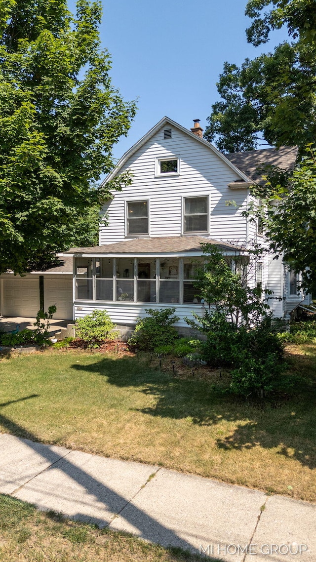 3255 Prairie St SW, Grandville, MI 49418 - farmhouse with a sunroom, a chimney, a front yard, and roof with shingles