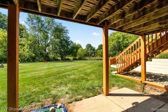5037 Scheuners Way, Howell, MI 48843 - view of green lawn featuring a patio area, stairway, and view of scattered trees