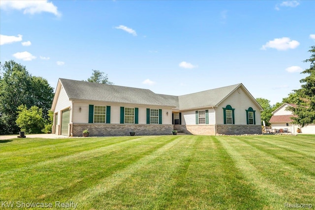 5037 Scheuners Way, Howell, MI 48843 - view of front of home featuring a front lawn, an attached garage, and brick siding
