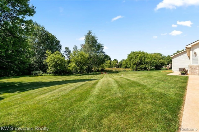5037 Scheuners Way, Howell, MI 48843 - view of green lawn with view of wooded area