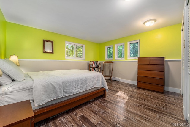 4729 Curtis Ln, Clarkston, MI 48346 - bedroom with baseboard heating and dark wood-style flooring