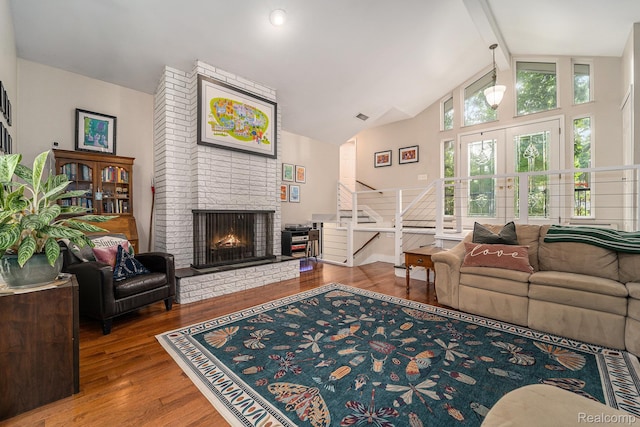 4729 Curtis Ln, Clarkston, MI 48346 - living area with stairway, wood finished floors, a brick fireplace, beam ceiling, and high vaulted ceiling