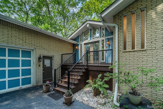 4729 Curtis Ln, Clarkston, MI 48346 - view of exterior entry featuring asphalt driveway, french doors, and brick siding
