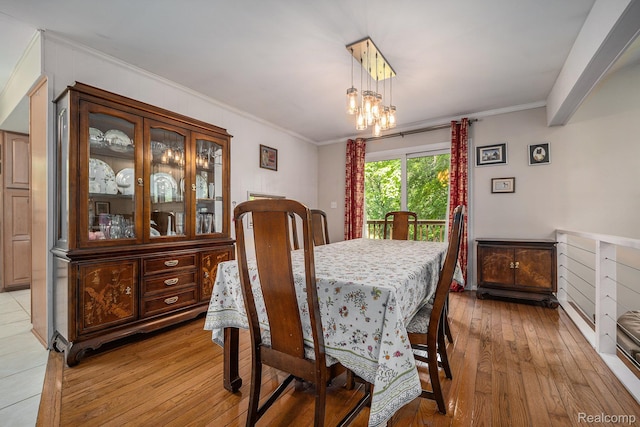 4729 Curtis Ln, Clarkston, MI 48346 - dining area with light wood finished floors, crown molding, and a chandelier