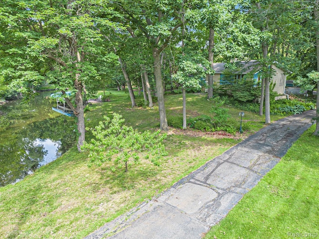 4729 Curtis Ln, Clarkston, MI 48346 - view of grassy yard with driveway and a water view