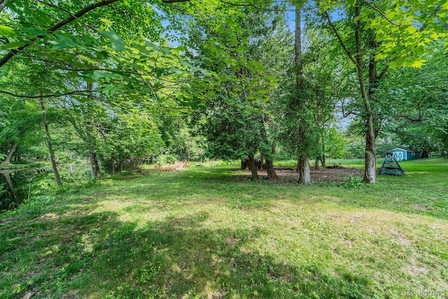 4729 Curtis Ln, Clarkston, MI 48346 - view of green lawn with a shed