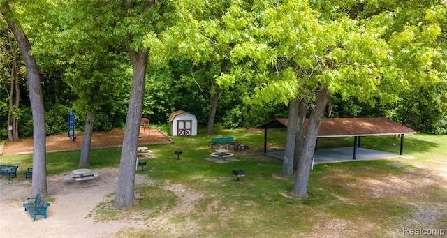 4729 Curtis Ln, Clarkston, MI 48346 - view of green lawn featuring a storage unit and a carport