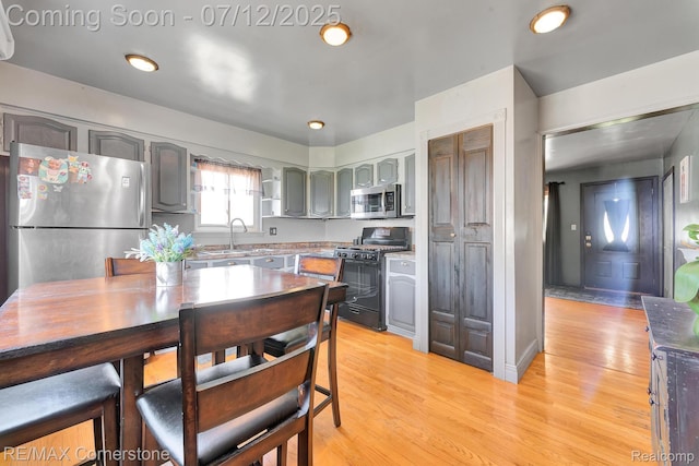 34060 Avondale St, Westland, MI 48186 - kitchen featuring appliances with stainless steel finishes, gray cabinets, and light wood finished floors