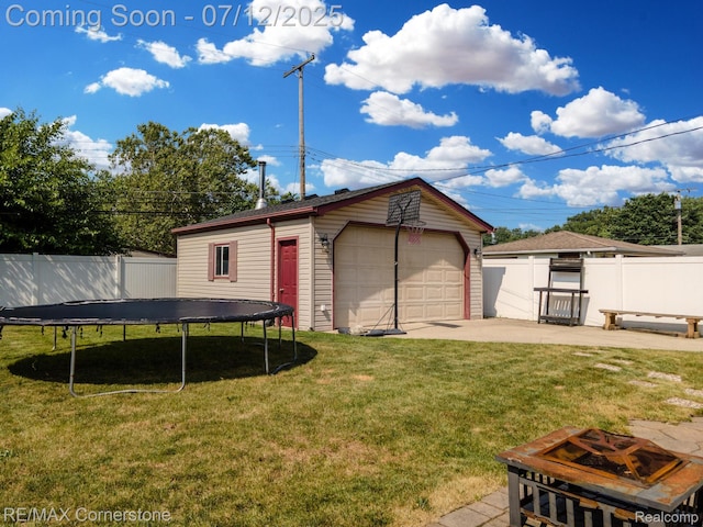34060 Avondale St, Westland, MI 48186 - back of house featuring a trampoline, a detached garage, and an outdoor structure