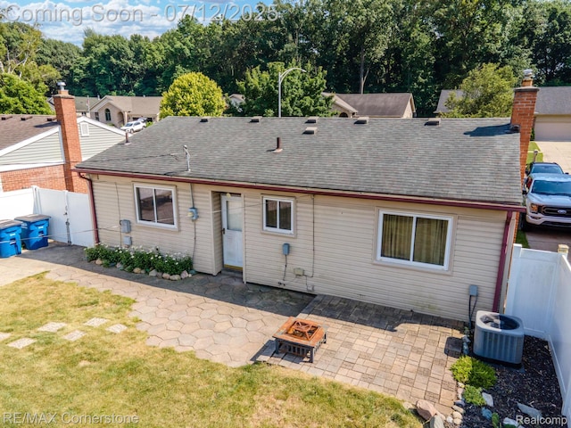 34060 Avondale St, Westland, MI 48186 - back of property with a fire pit, a shingled roof, a patio, and a fenced backyard