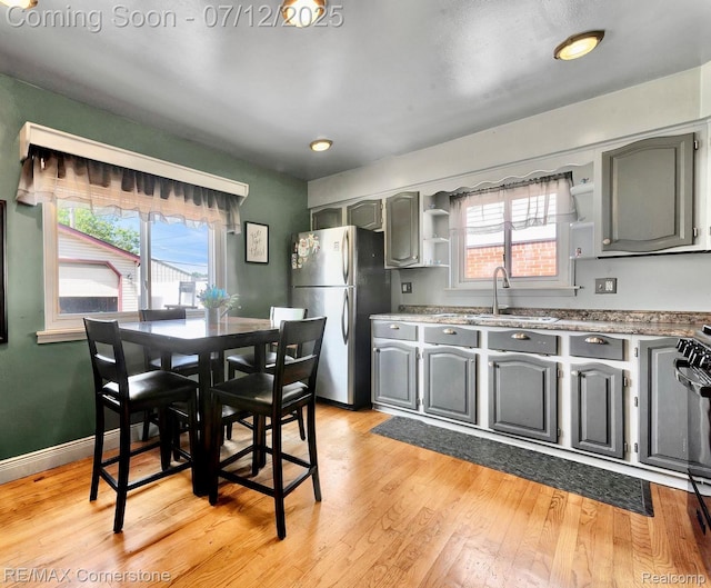 34060 Avondale St, Westland, MI 48186 - kitchen featuring freestanding refrigerator, open shelves, gray cabinetry, and healthy amount of natural light