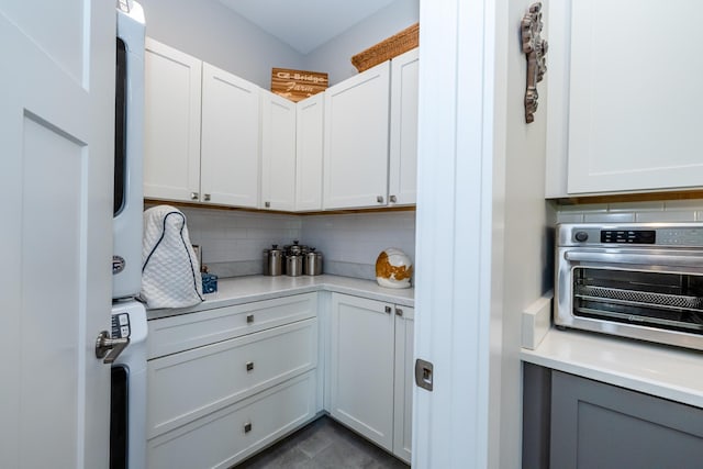 4785 Lauren Ln, Saint Joseph, MI 49085 - kitchen with backsplash, light countertops, and white cabinets