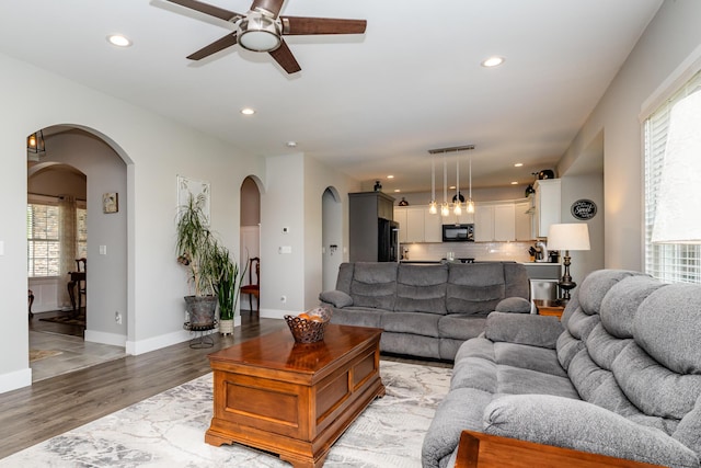 4785 Lauren Ln, Saint Joseph, MI 49085 - living area with arched walkways, ceiling fan, light wood-style flooring, healthy amount of natural light, and recessed lighting