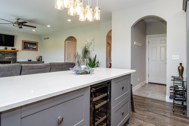4785 Lauren Ln, Saint Joseph, MI 49085 - kitchen with wine cooler, gray cabinets, a ceiling fan, arched walkways, and recessed lighting