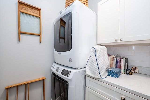 4785 Lauren Ln, Saint Joseph, MI 49085 - laundry room with cabinet space and stacked washer / dryer