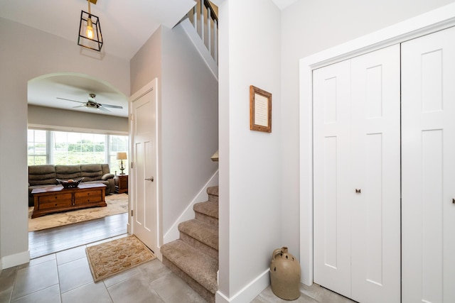 4785 Lauren Ln, Saint Joseph, MI 49085 - entrance foyer with ceiling fan, stairway, arched walkways, and light tile patterned flooring