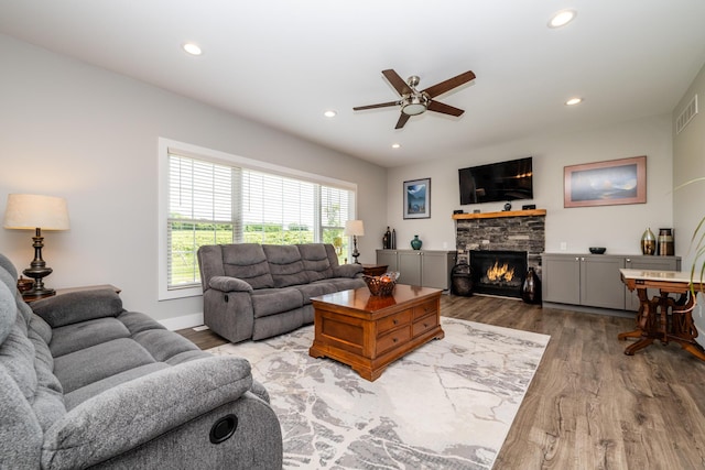 4785 Lauren Ln, Saint Joseph, MI 49085 - living room with wood finished floors, a ceiling fan, a stone fireplace, and recessed lighting