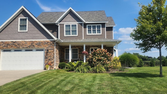 4785 Lauren Ln, Saint Joseph, MI 49085 - view of front facade with a front yard, concrete driveway, a porch, a garage, and stone siding