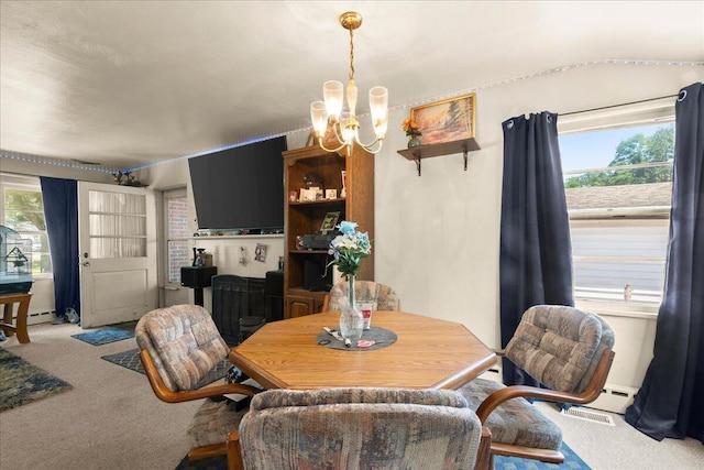 3658 Lake Harbor Rd, Norton Shores, MI 49441 - carpeted dining room with a chandelier and baseboard heating