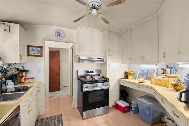 3658 Lake Harbor Rd, Norton Shores, MI 49441 - kitchen with stainless steel appliances, exhaust hood, light wood-type flooring, light countertops, and a ceiling fan
