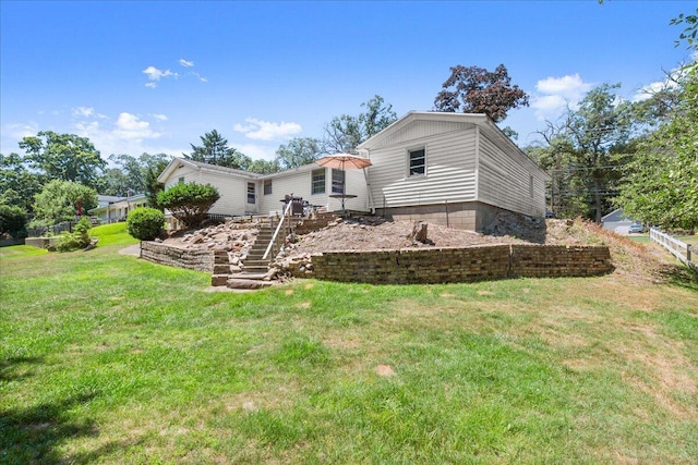 3658 Lake Harbor Rd, Norton Shores, MI 49441 - rear view of house featuring a yard and stairway