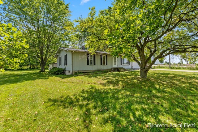 5640 Kraft Ave SE, Grand Rapids, MI 49512 - view of front of home featuring a front yard and board and batten siding