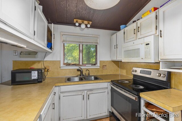 5640 Kraft Ave SE, Grand Rapids, MI 49512 - kitchen with electric range, white microwave, black microwave, white cabinetry, and wood ceiling