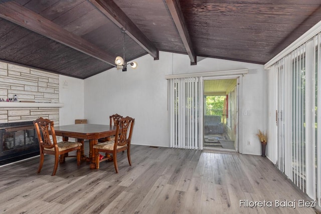5640 Kraft Ave SE, Grand Rapids, MI 49512 - dining space featuring wood finished floors, wood ceiling, and a stone fireplace