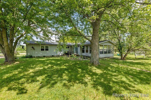 5640 Kraft Ave SE, Grand Rapids, MI 49512 - rear view of property featuring a sunroom and a yard