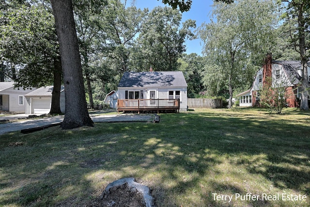 2025 Whitehall Rd, Muskegon, MI 49445 - view of yard featuring a deck, a garage, and view of wooded area