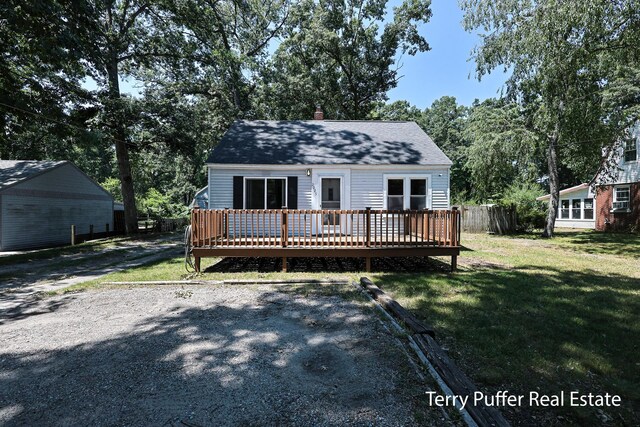 2025 Whitehall Rd, Muskegon, MI 49445 - view of front of house with a wooden deck, a front yard, a chimney, and roof with shingles