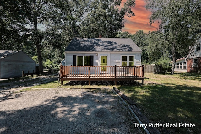 2025 Whitehall Rd, Muskegon, MI 49445 - view of front facade with a deck, a lawn, and roof with shingles
