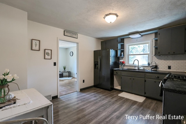 2025 Whitehall Rd, Muskegon, MI 49445 - kitchen featuring fridge with ice dispenser, open shelves, tasteful backsplash, dark countertops, and dark wood-style floors